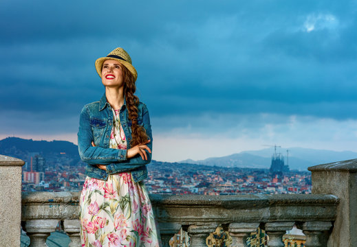 smiling elegant woman in Barcelona, Spain looking into distance