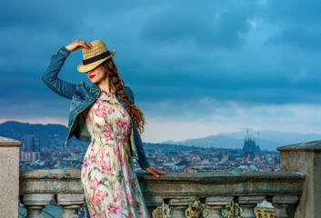 traveller woman against city panorama of Barcelona posing