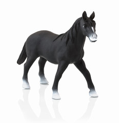 Obraz na płótnie Canvas Black horse toy isolated on white background with shadow reflection. Children´s small plastic black horse on white backdrop. Miniature plastic model of horse.