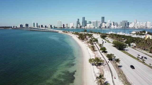 Beautiful aerial 4k drone panorama flight over huge highway road in big city Miami East Coast ocean coastline seascape