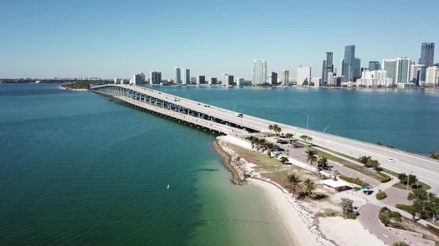 Marvelous aerial 4k drone panorama flight over huge highway road in big city Miami East Coast ocean coastline seascape