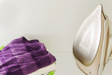 clothing beside iron prepared for Ironing