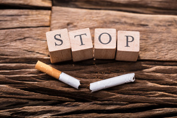 Cigarette And Wooden Blocks Showing Stop Word