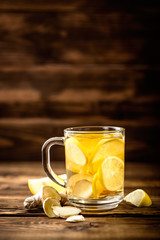hot sweet ginger tea with lemon in glass mug