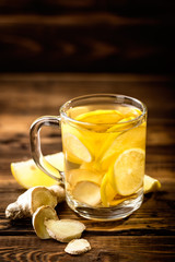 hot sweet ginger tea with lemon in glass mug