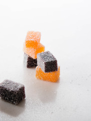 Assortment of colorful fruit jelly on white marble.