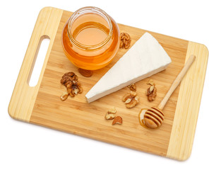Fototapeta na wymiar brie or camambert cheese and honey on a white background