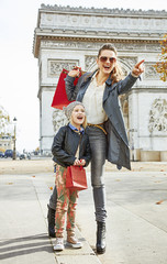 happy mother and child in Paris, France pointing on something