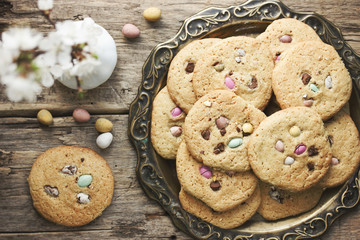 Easter egg cookies - homemade big soft american biscuits with chocolate candy mini eggs, sweet easter treats
