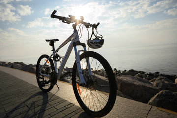 mountain bike with helmet on sunrise seaside