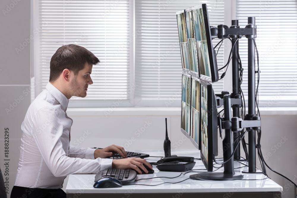 Aufkleber Operator Looking At Multiple Camera Footage On Computer