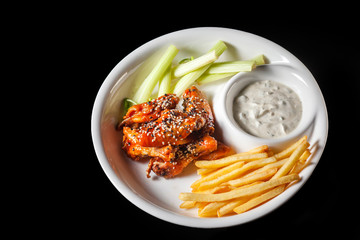 Chicken nuggets with french fries and ketchup on black background