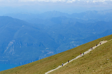 Mount Baldo, Italy - August 15, 2017: walking mountain tourism. people climb the mountain.