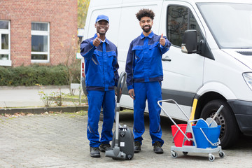 Portrait Of Two Happy Male Janitor