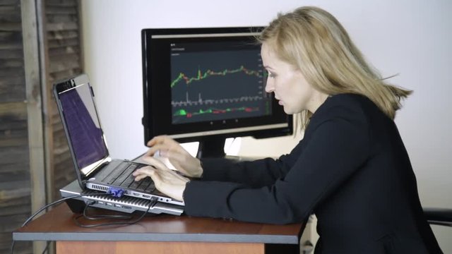 Work on a stock exchange. Businesswoman watching changes in the currency exchange chart