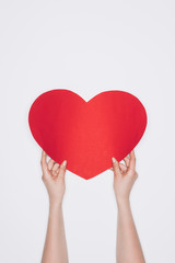 cropped shot of woman holding red heart isolated on white