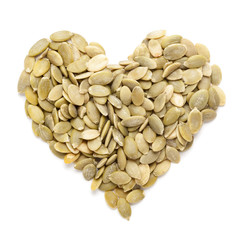 Organic Pumpkin seed (Cucurbita pepo)  in Heart Shape. Isolated on White Background.  Micro Closeup, Top view.