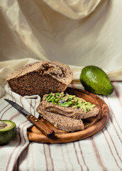 Avocado toast on gluten-free bread, rustic background. Guacamole with pumpkin seeds.Vegetarian food and Superfood diet concept.