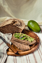 Avocado toast on gluten-free bread, rustic background. Guacamole with pumpkin seeds.Vegetarian food and Superfood healthy lifestyle concept.