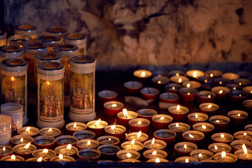 a lot of burning candles in the Catholic church.
