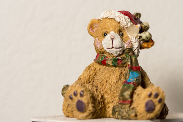A ceramic teddy bear figure at christmas time