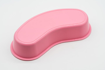 Pink plastic kidney tray medical equipment isolated on white