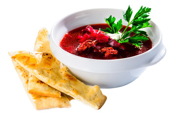 Ukrainian traditional borsch and bread sticks. Beetroot red soup with meat, garlic and mint in a plate on white background