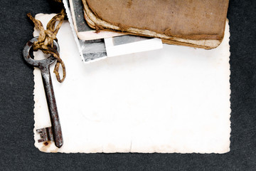 Rusty key, old book and empty photography as a memories  metaphor. Copy space