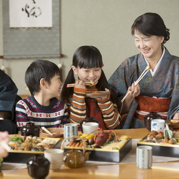 おせち料理を食べる祖母と孫