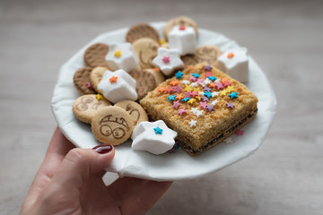 Variety of sweet festive cookies on a wooden background