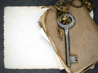 Rusty key, old book and empty photography as a memories metaphor