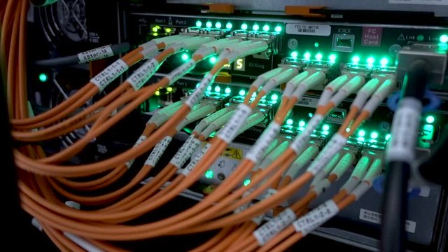 Fiber Optical connector interface. Rack Mounted Servers In A Server Room, Server rack audio cable. Severs computer in a rack at the large data center