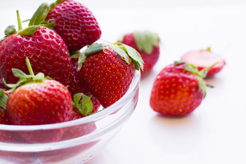 Healthy Food Dessert concept. A close up a glass of a bowl of strawberries on white
