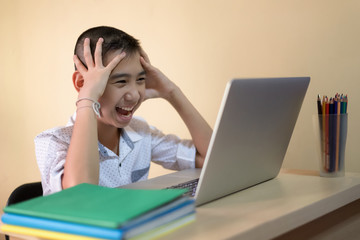 Young boy student, studying computer and is happy to learn new things new