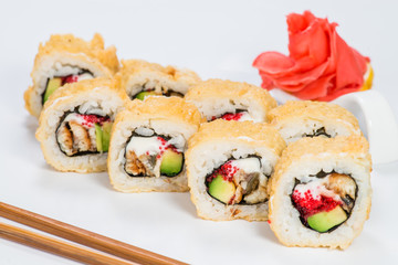 Traditional Japanese cuisine. Tasty sushi rolls with rice, cream cheese, salmon and tuna on light background