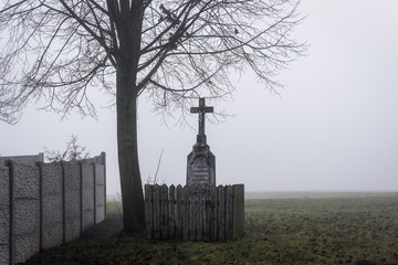 Christ's torture next to the wall beneath the tree emerging from the mist in the highlands