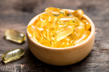 Fish oil capsules with omega 3 and vitamin D. healthy diet concept.