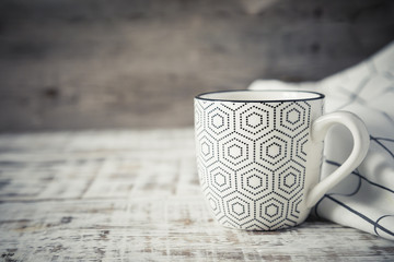 Cup of coffee on a wooden table with copy space