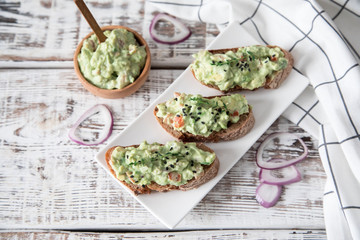 toast with guacamole, seeds and herbs. A cup of coffee. Healyhy Breakfast concept