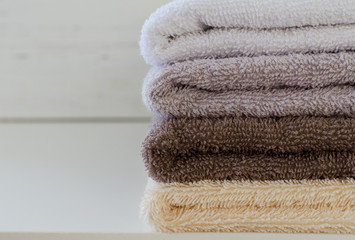 Fototapeta na wymiar stack of towels on white wooden background