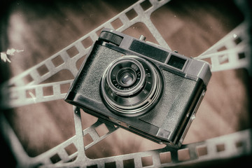 Old retro rangefinder camera on film perforation