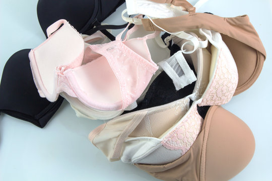 pile of many and different bra on white background