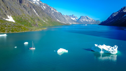 Yacht and iceberg. Amazing aerophoto. Greenland nature fjord. 