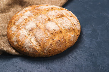 Freshly baked round homemade breads on black background.