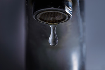 Bathroom tap leaking water drops