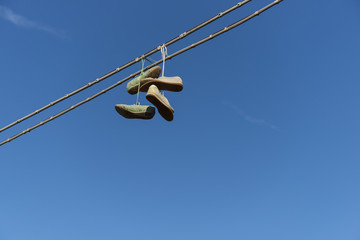 Shoefiti Old shoes hanging on electric cables