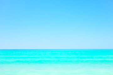 Fototapeta na wymiar Blurred sea background. Concept of beach in summer.