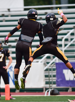 High School Football Players Celebrating A Touchdown