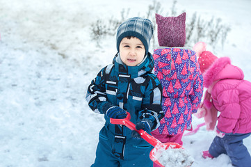 child in the snow with a shovel