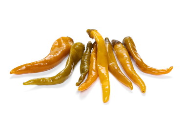 pile hot wet yellow peppers isolated on white background